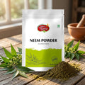 A stand-up pouch of Nature's Basket Neem Powder on a solid beige background. The packaging is white with a bright green lower section, featuring the brand logo and the text 'NEEM POWDER'.