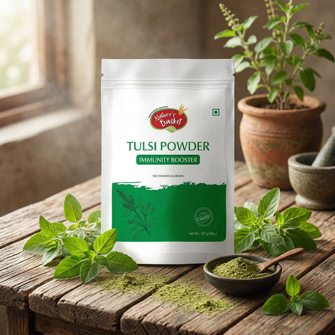 Nature's Basket Tulsi Powder Immunity Booster in a white resealable stand-up pouch with green and red branding, shown on a plain beige background.
